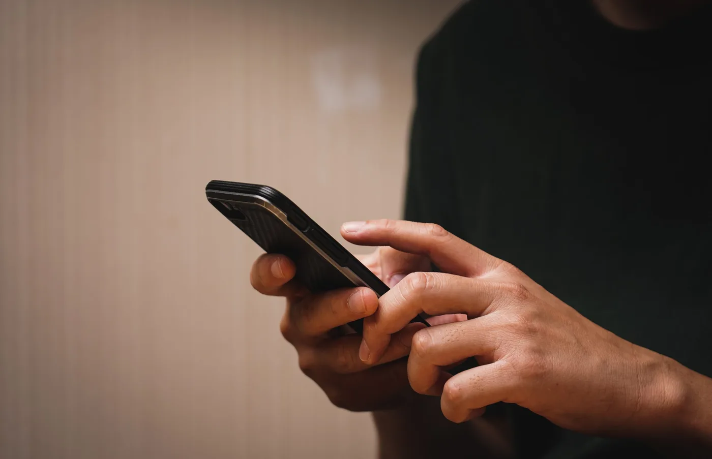 vecteezy_man-s-hand-using-a-mobile-phone-browsing-mobile-device-apps_18772544-scaled